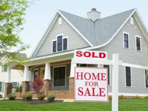 House with for sale sign in front yard. How Buyers Can Prepare For Today’s Hot Market