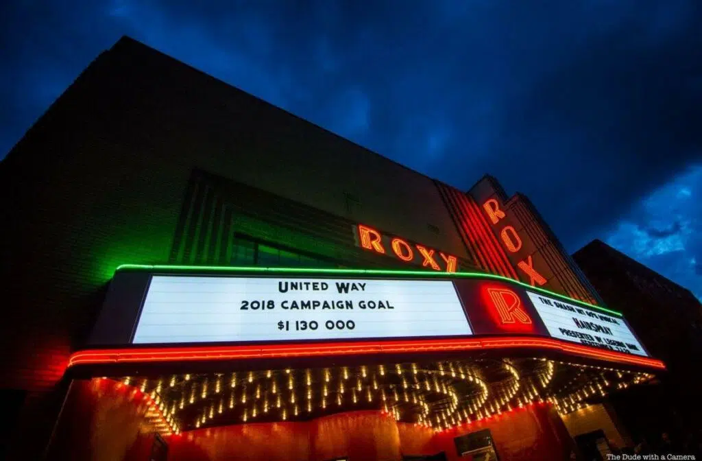 The Roxy Theater lit up at night. 
