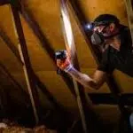 A home inspector in the attic of a home in Clarksville TN